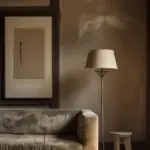 Cozy living room with sofa, lamp, and art piece.