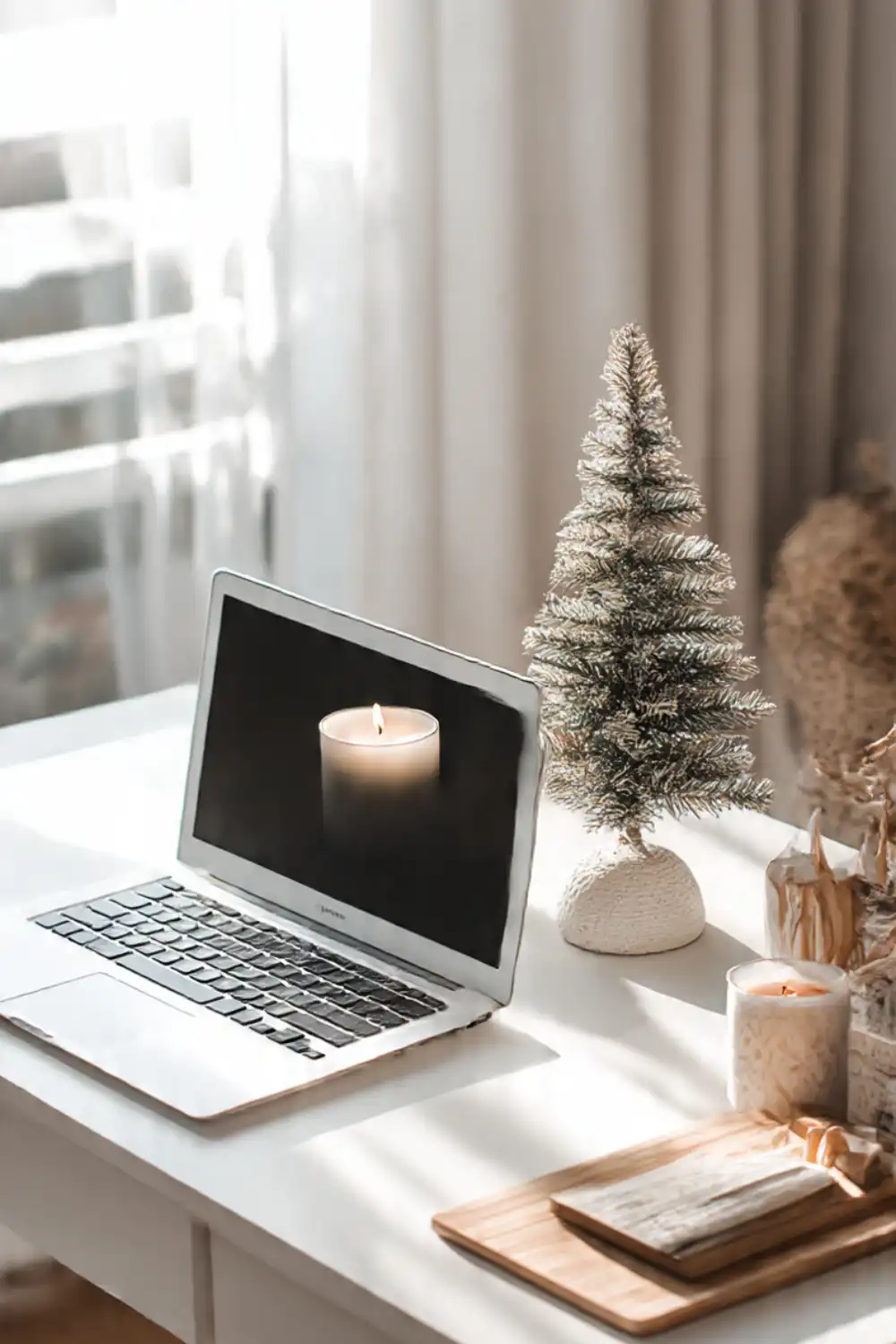 Cozy workspace with laptop and small Christmas tree