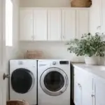 Modern laundry room with washer, dryer, and cabinets.