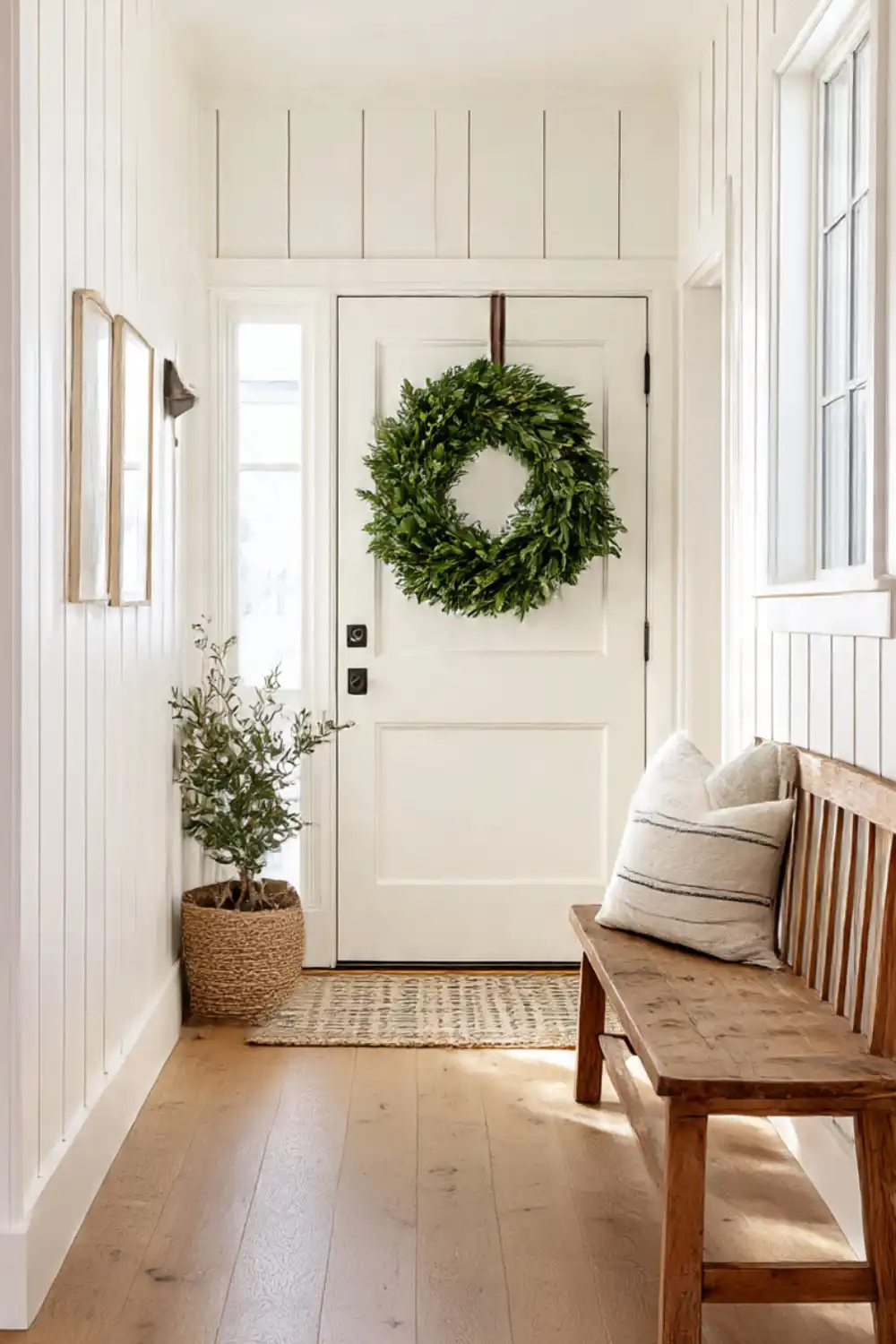 Cozy entryway with wreath, plant, and bench