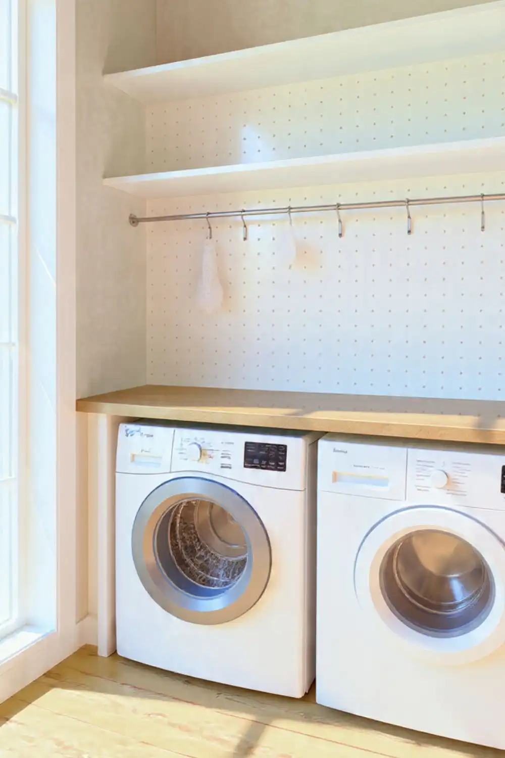 Laundry room with washer and dryer units.