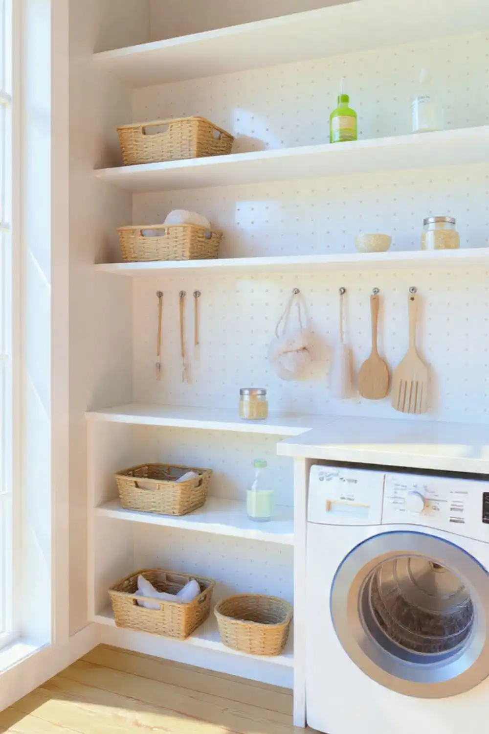 Organized laundry room with shelves and washing machine.