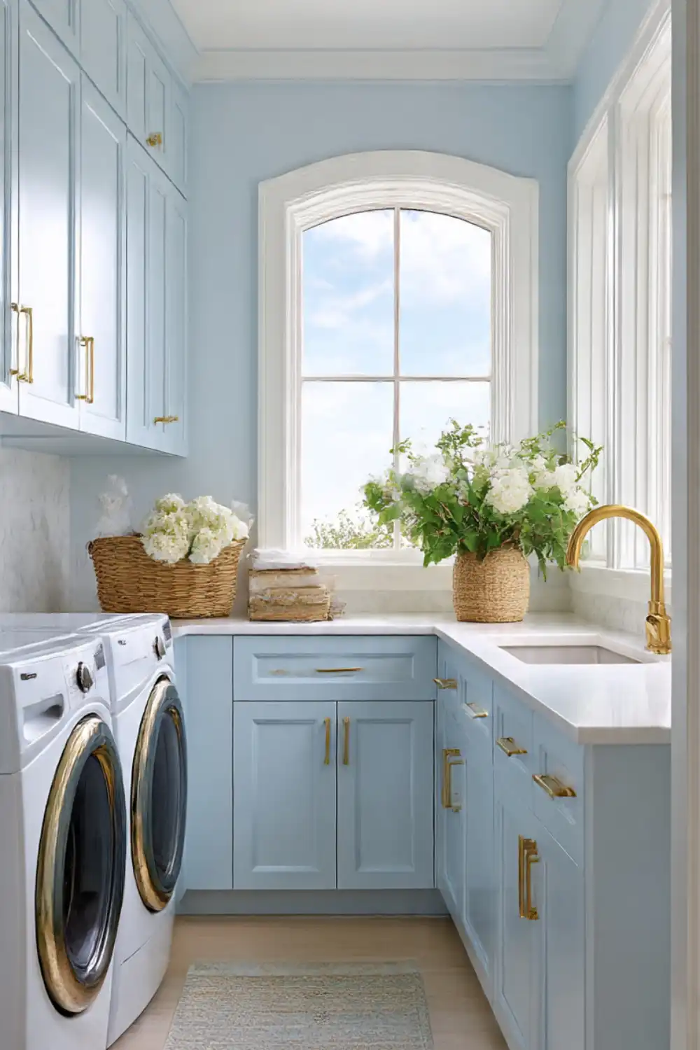 Light blue laundry room with sink and flowers